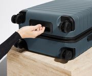 The Bigger Carry-On suitcase in Coast Blue shown from below highlighting the underside grab handle
